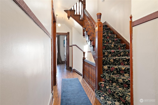 stairway with hardwood / wood-style flooring