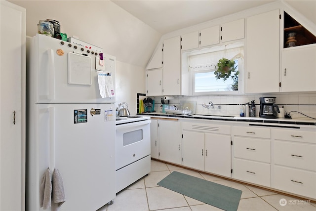 kitchen featuring vaulted ceiling, sink, white cabinetry, white appliances, and decorative backsplash