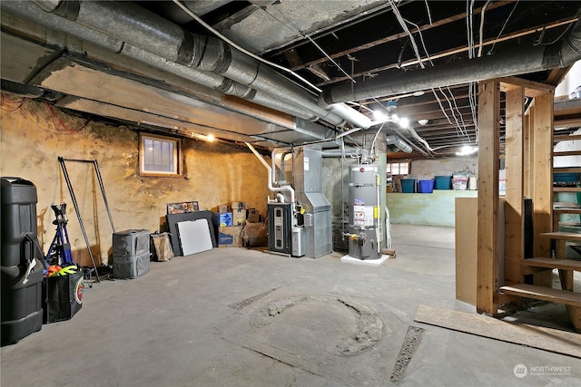 basement featuring heating unit and water heater