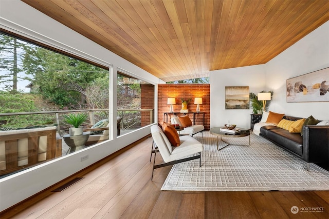 sunroom / solarium featuring lofted ceiling and wood ceiling