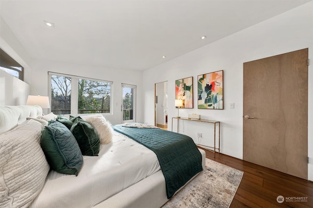 bedroom with dark hardwood / wood-style floors