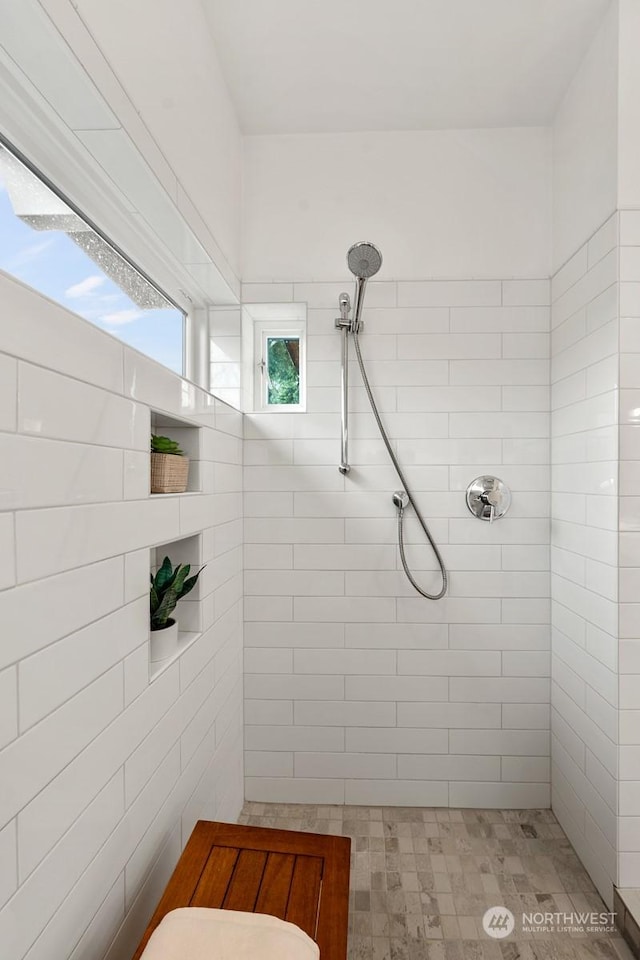 bathroom with a tile shower