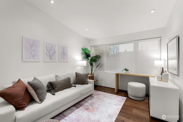 living room with hardwood / wood-style floors and vaulted ceiling