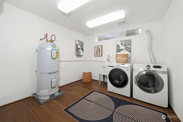 clothes washing area with washer and dryer and dark hardwood / wood-style floors