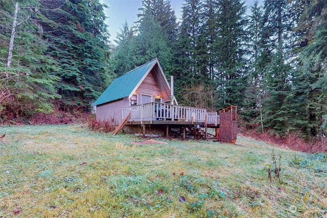 exterior space featuring a yard and a wooden deck