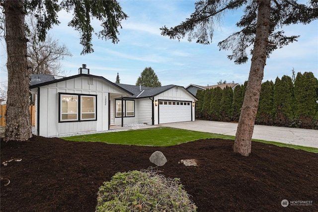 view of front of property with a garage and a front lawn