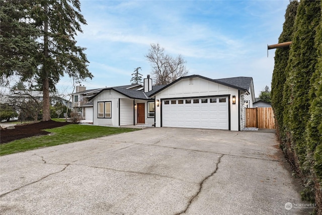 single story home with a front yard and a garage