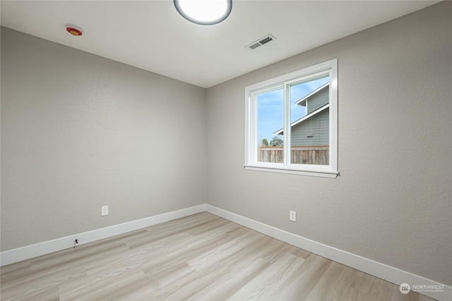 spare room with light hardwood / wood-style flooring