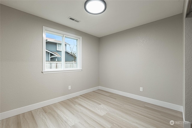 spare room featuring light hardwood / wood-style flooring