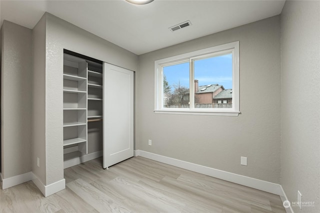 unfurnished bedroom featuring light wood-type flooring