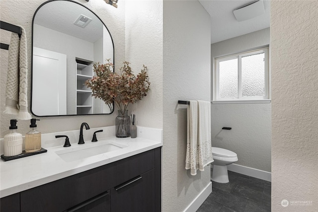 bathroom with toilet and vanity