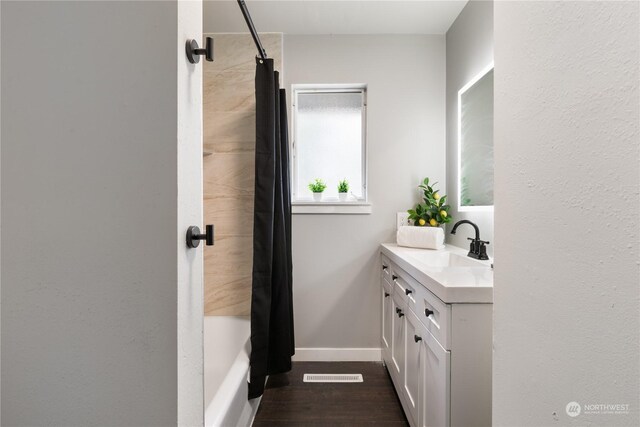 bathroom with vanity and shower / tub combo with curtain