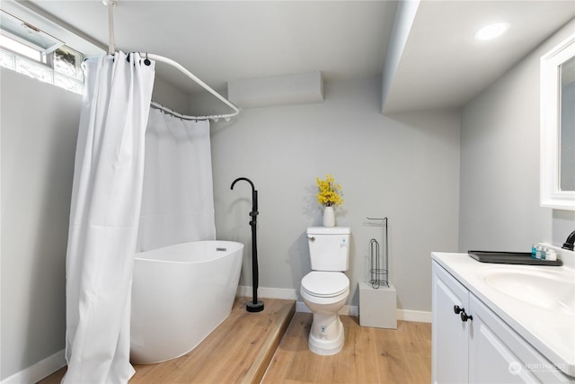 bathroom featuring vanity, toilet, and hardwood / wood-style floors