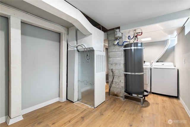 utility room featuring washer and clothes dryer and secured water heater