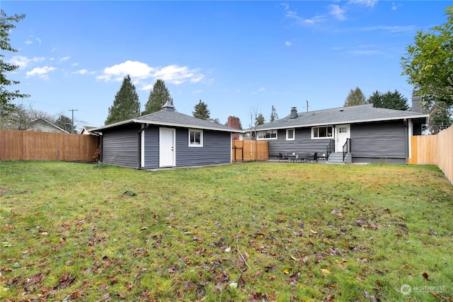 back of house featuring a yard