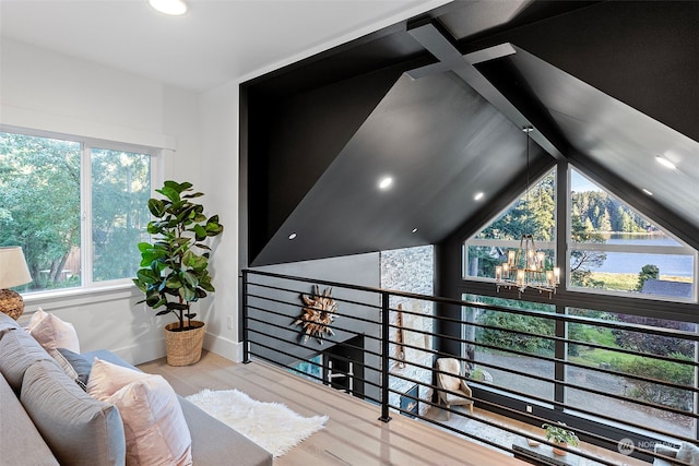 interior space featuring wood-type flooring, a water view, and a notable chandelier