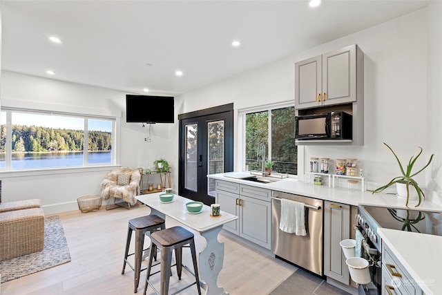 kitchen featuring stainless steel appliances, sink, french doors, and gray cabinets