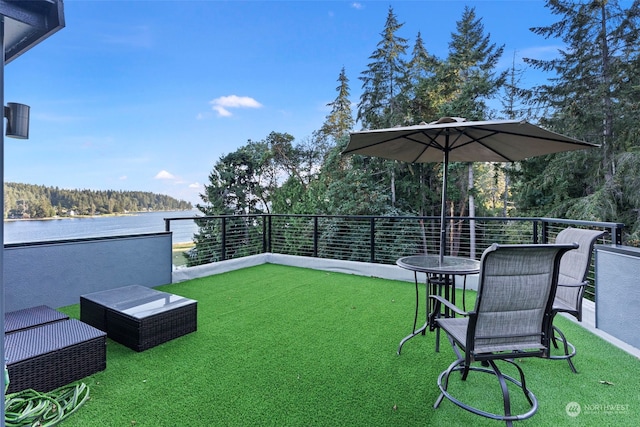 view of yard featuring a water view and a balcony