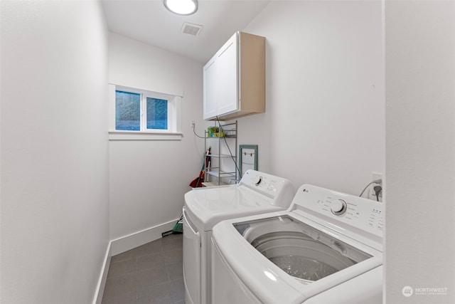 clothes washing area with cabinets, tile patterned flooring, and independent washer and dryer