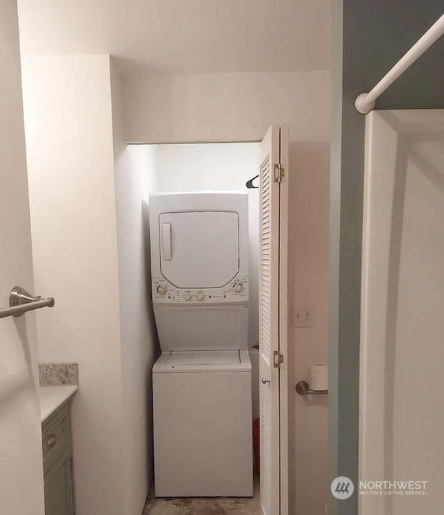 washroom with stacked washing maching and dryer