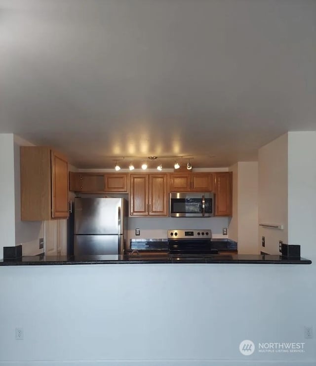 kitchen featuring appliances with stainless steel finishes and kitchen peninsula