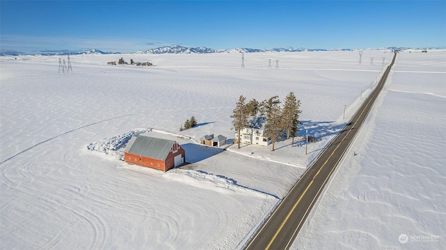 snowy aerial view with a mountain view