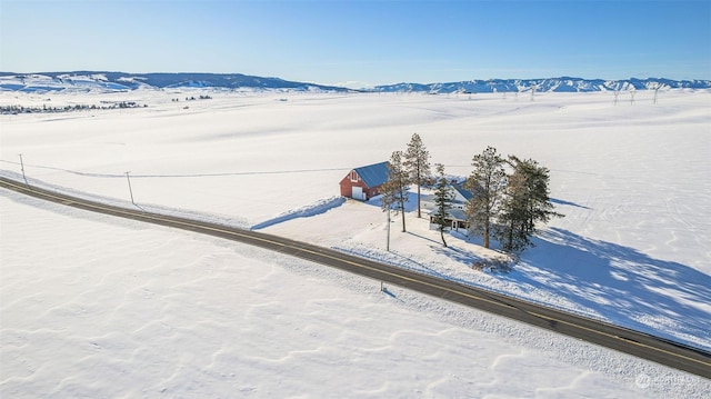 snowy aerial view featuring a mountain view