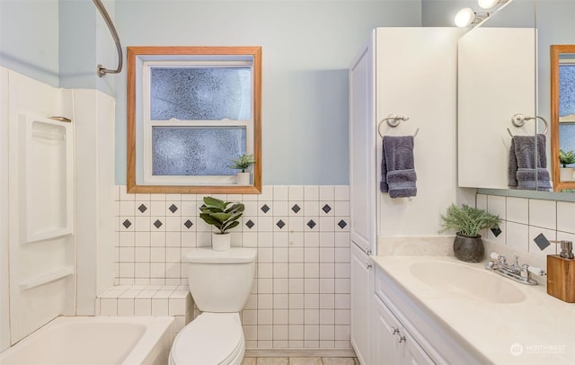 bathroom with toilet, vanity, and tile walls