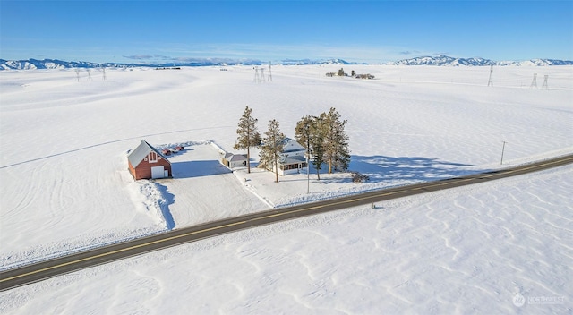 snowy aerial view with a mountain view