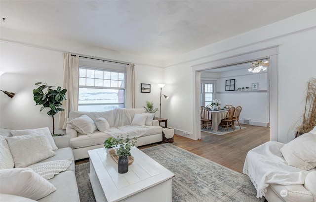 living room with ceiling fan and hardwood / wood-style floors