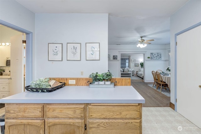 kitchen featuring light brown cabinetry, ceiling fan, and light hardwood / wood-style flooring