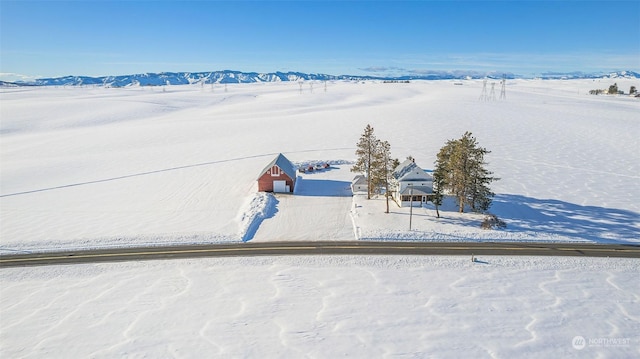 snowy aerial view featuring a mountain view