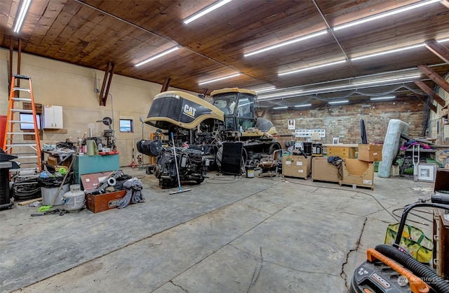 garage featuring a workshop area and wooden ceiling