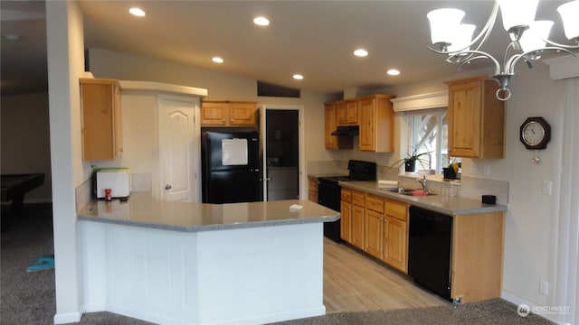 kitchen with sink, an inviting chandelier, light wood-type flooring, hanging light fixtures, and black appliances