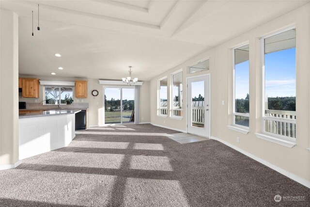 unfurnished living room with light carpet and an inviting chandelier