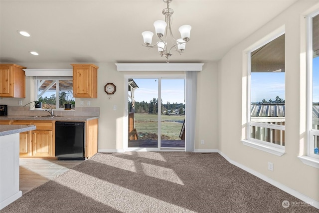 kitchen with light colored carpet, dishwasher, and a healthy amount of sunlight