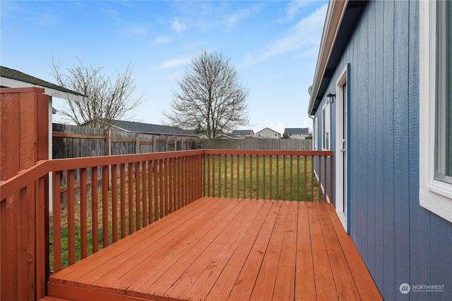 wooden deck with a lawn