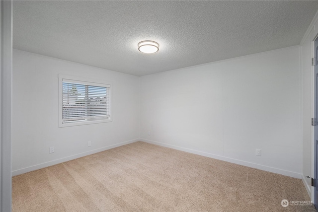 carpeted spare room featuring a textured ceiling