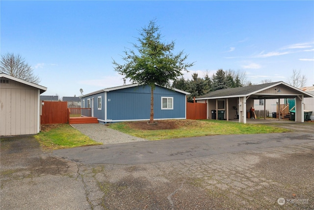 view of side of home featuring an outbuilding and a carport