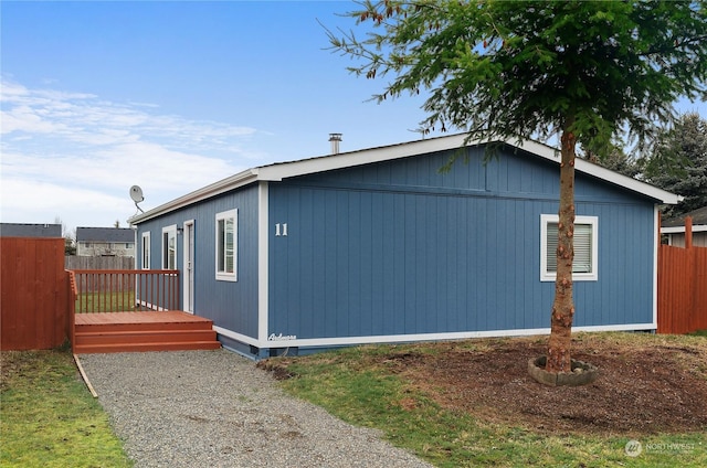 view of side of home with a deck