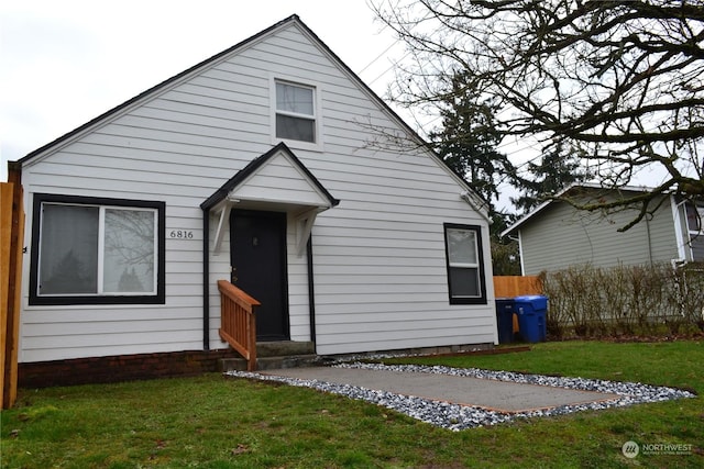 bungalow-style home featuring a front yard