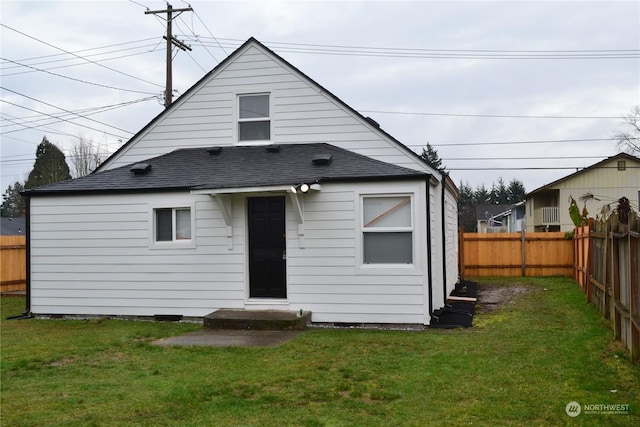 back of property featuring a lawn