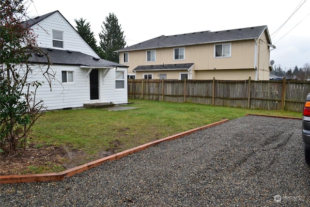 rear view of property with a lawn