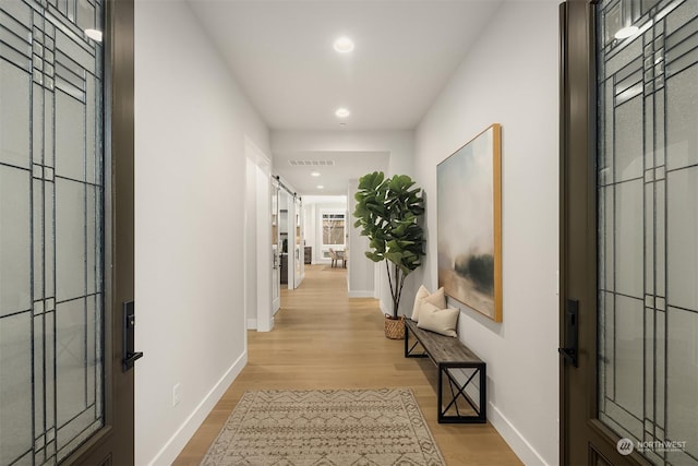 hall with light hardwood / wood-style flooring