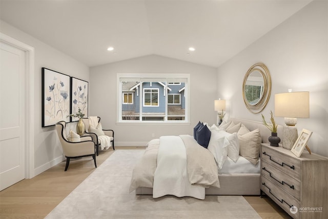 bedroom featuring lofted ceiling and light hardwood / wood-style floors