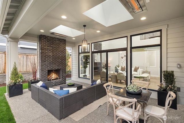 view of patio / terrace with an outdoor living space with a fireplace