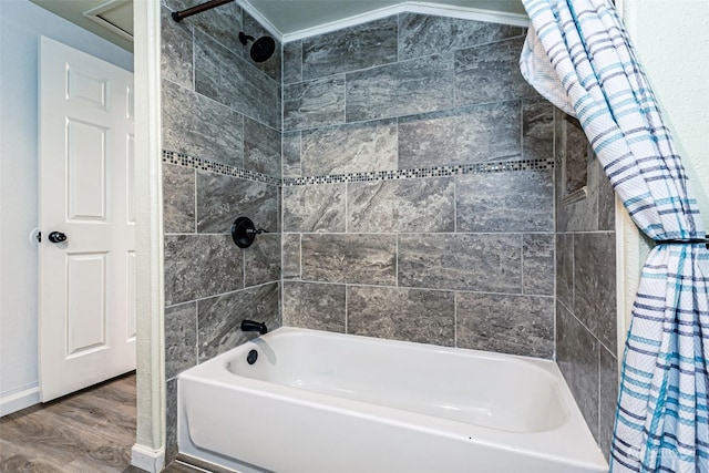 bathroom with tiled shower / bath, crown molding, and hardwood / wood-style floors