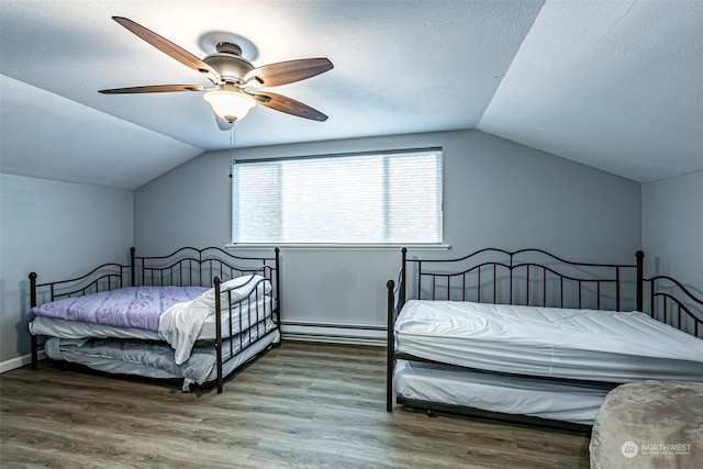 bedroom with vaulted ceiling, baseboard heating, ceiling fan, and hardwood / wood-style flooring