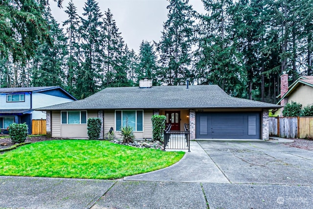 single story home featuring a garage and a front lawn