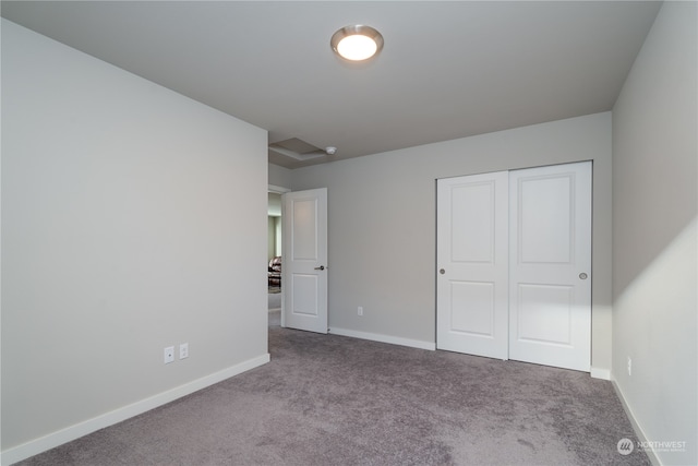 unfurnished bedroom with a closet, baseboards, and carpet floors